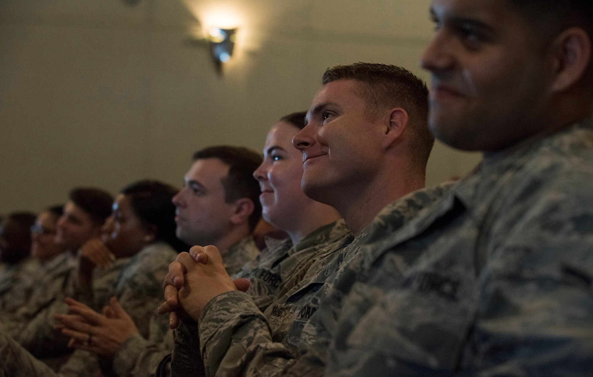 Airmen smile and listen tentatively during an all call with Chief Master Sgt. of the Air Force, Kaleth O. Wright, on Aug. 3, 2018 at RAF Alconbury, United Kingdom. The purpose of his visit was to meet with U.S. Air Force Airmen, speak about some current Air Force topics and learn more about the 501st CSW mission. (U.S. Air Force photo by TSgt. Brian Kimball)