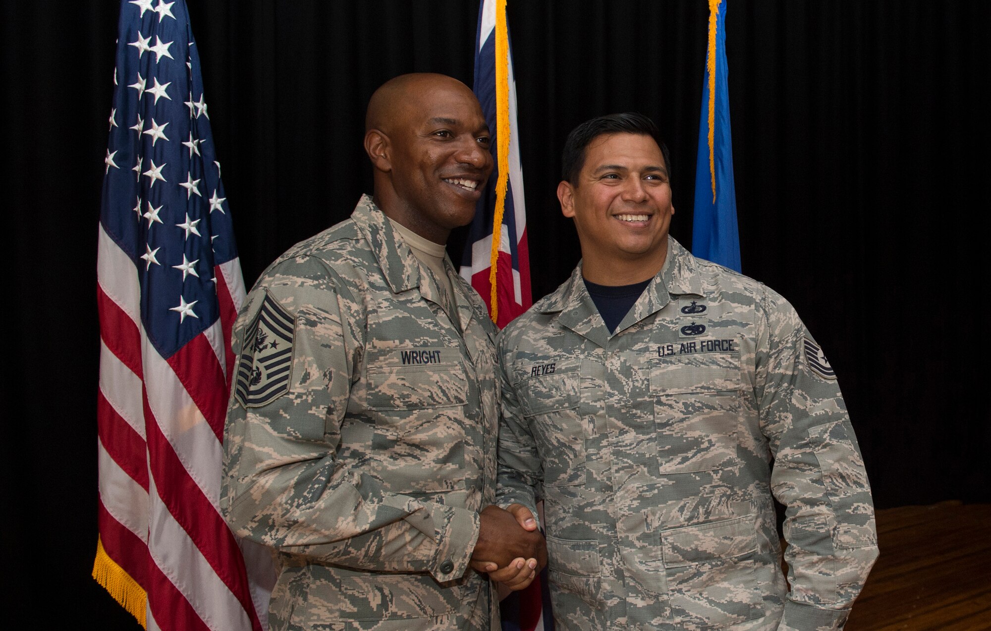 Chief Master Sgt. of the Air Force (left), Kaleth O. Wright, has his photo  taken with Tech Sgt. Michael Reyes (right) from the 501st Combat Support Wing (CSW) during an all call on Aug. 3, 2018 at RAF Alconbury, United Kingdom. The purpose of his visit was to meet with U.S. Air Force Airmen, speak about some current Air Force topics and learn more about the 501st CSW mission. (U.S. Air Force photo by TSgt. Brian Kimball)