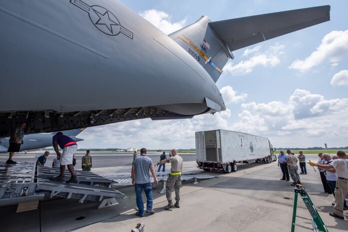 Members of the 437th Aerial Port Squadron and Space and Naval Warfare Systems Center Atlantic engineers conduct a test load of a Large Mobile Air Traffic Control Tower onto a C-17 Globemaster III July 26, 2018, at the Joint Base Charleston Air Base.