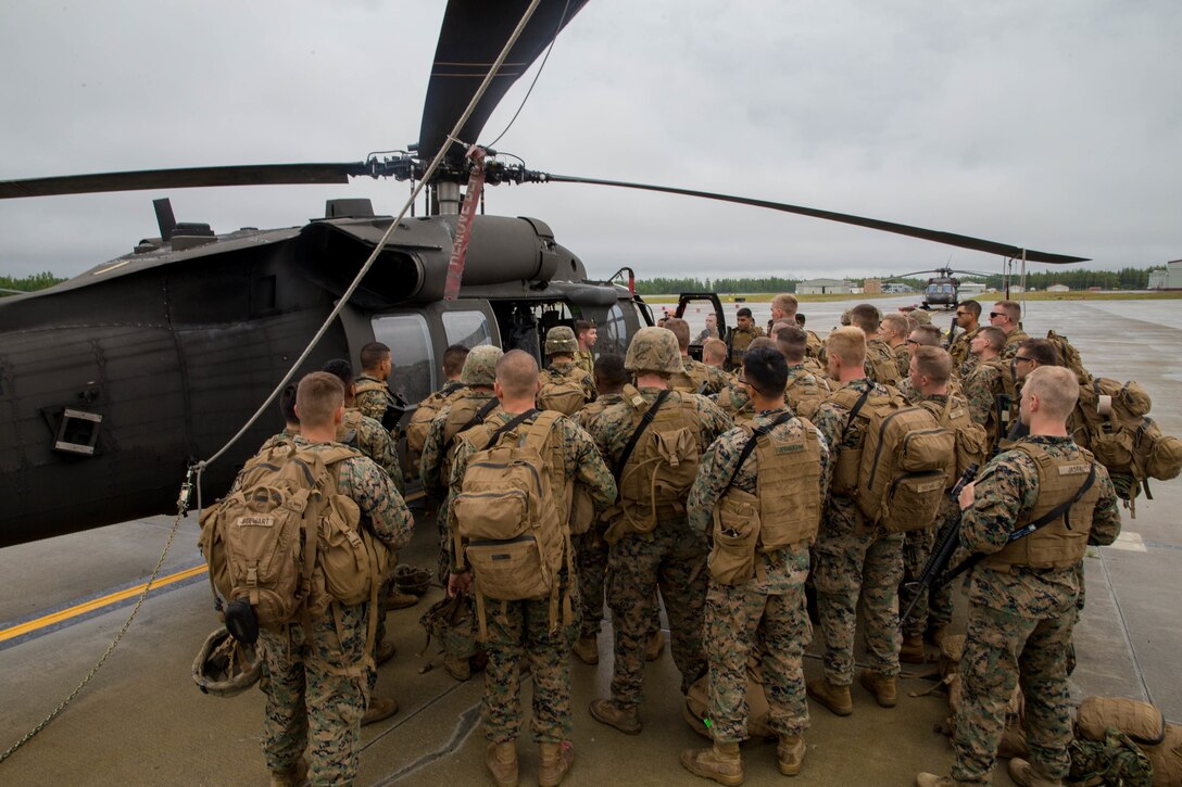 Marines competing in the 4th Marine Division Annual Rifle Squad Competition, receive lessons on how to properly board and ride in a U.S. Army Sikorsky UH-60 Black Hawk at Joint Base Elmendorf-Richardson, Anchorage, Alaska, August 2, 2018. Super Squad Competitions were designed to evaluate a 14-man infantry squad throughout an extensive field and live-fire evolution. (U.S. Marine Corps photo by Lance Cpl. Samantha Schwoch/released)