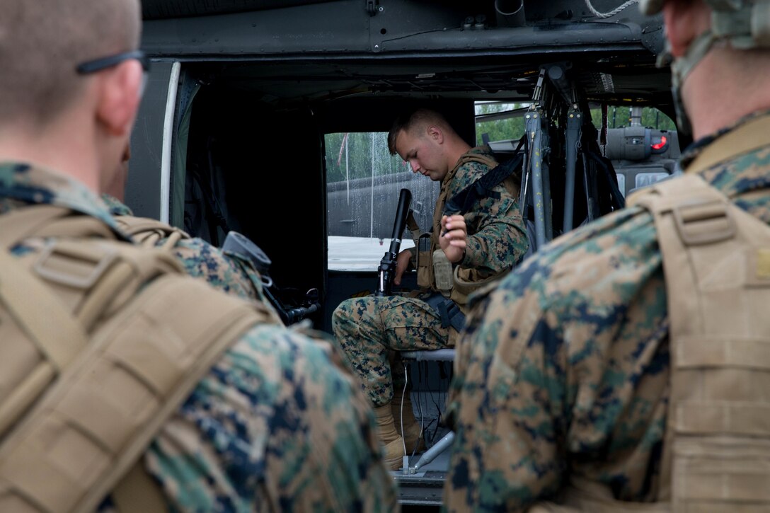 Marines competing in the 4th Marine Division Annual Rifle Squad Competition, receive lessons on how to properly board and ride in a U.S. Army Sikorsky UH-60 Black Hawk at Joint Base Elmendorf-Richardson, Anchorage, Alaska, August 2, 2018. Super Squad Competitions were designed to evaluate a 14-man infantry squad throughout an extensive field and live-fire evolution. (U.S. Marine Corps photo by Lance Cpl. Samantha Schwoch/released)