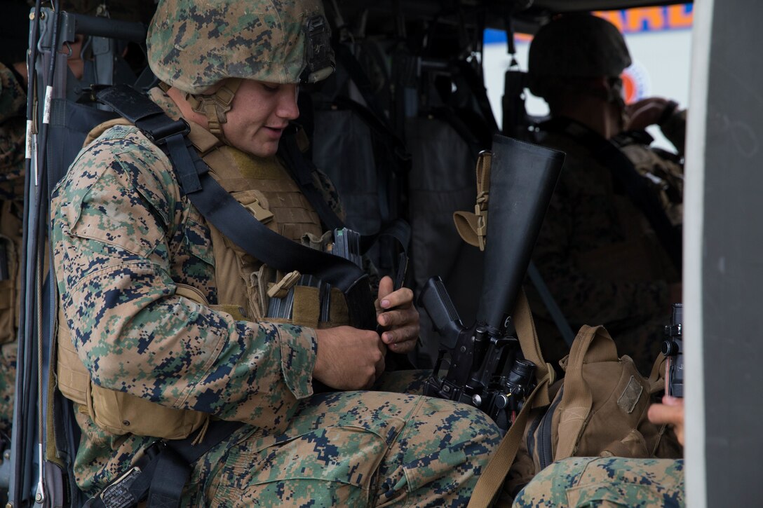 Marines, with Charlie Company, 1st Battalion, 23rd Marine Regiment, competing in the 4th Marine Division Annual Rifle Squad Competition, practice properly boarding a U.S. Army Sikorsky UH-60 Black Hawk at Joint Base Elmendorf-Richardson, Anchorage, Alaska, August 2, 2018. Super Squad Competitions were designed to evaluate a 14-man infantry squad throughout an extensive field and live-fire evolution. (U.S. Marine Corps photo by Lance Cpl. Samantha Schwoch/released)