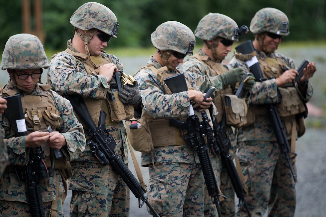 Marines, with Charlie Company, 1st Battalion, 23rd Marine Regiment, competing in the 4th Marine Division Annual Rifle Squad Competition, load 100 rounds of ammunition into magazines on the Unknown Distance range at Joint Base Elmendorf-Richardson, Anchorage, Alaska, August 2, 2018. Super Squad Competitions were designed to evaluate a 14-man infantry squad throughout an extensive field and live-fire evolution. (U.S. Marine Corps photo by Lance Cpl. Samantha Schwoch/released)