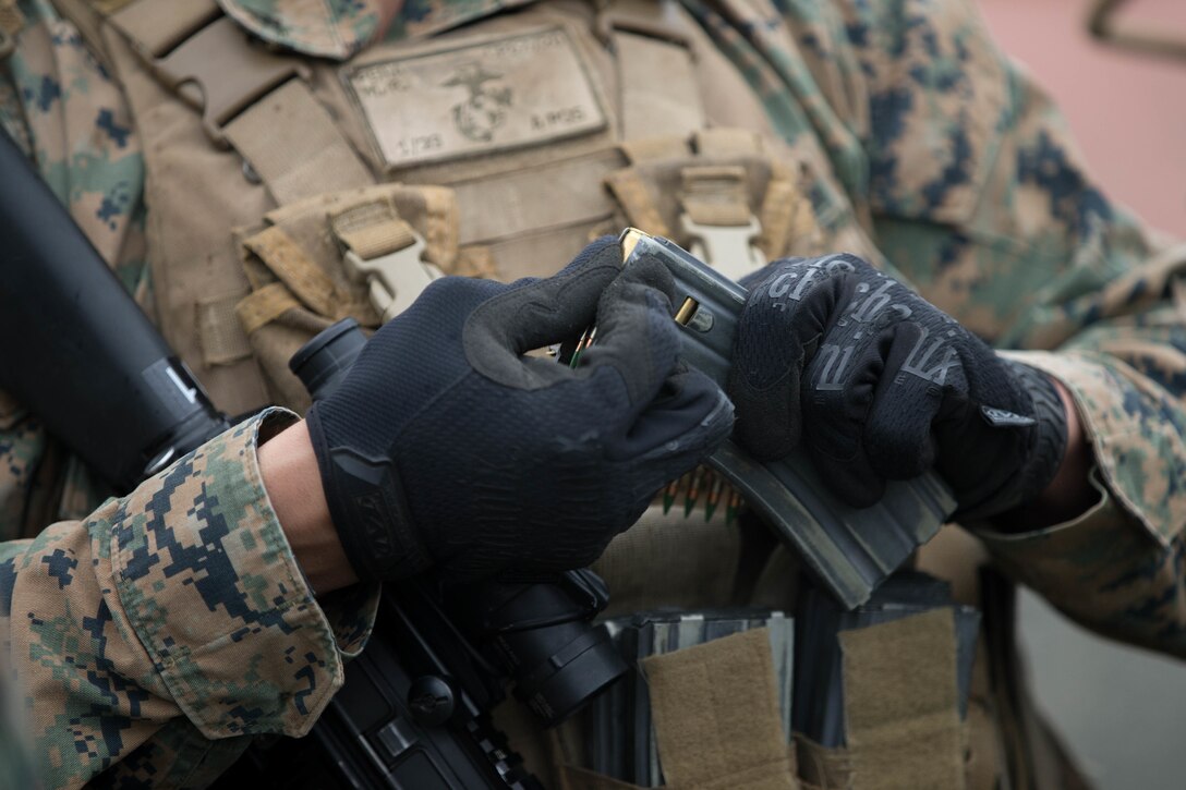 A Marine, with Charlie Company, 1st Battalion, 23rd Marine Regiment, competing in the 4th Marine Division Annual Rifle Squad Competition, loads 100 rounds of ammunition into magazines on the Unknown Distance range at Joint Base Elmendorf-Richardson, Anchorage, Alaska, August 2, 2018. Super Squad Competitions were designed to evaluate a 14-man infantry squad throughout an extensive field and live-fire evolution. (U.S. Marine Corps photo by Lance Cpl. Samantha Schwoch/released)