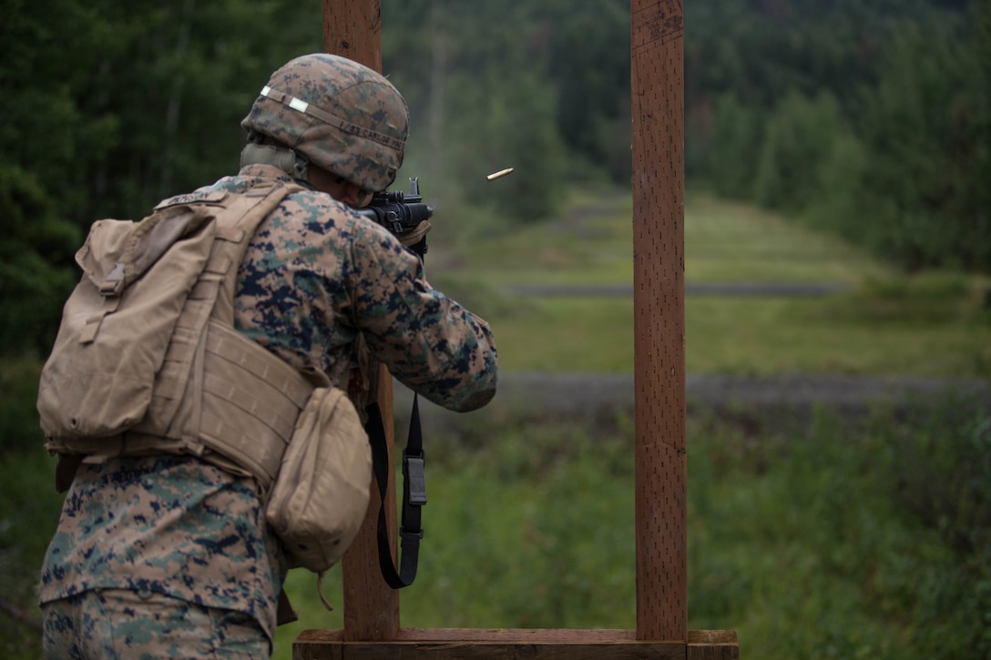 Cpl. Gary Denson, with Charlie Company, 1st Battalion, 23rd Marine Regiment, a competitor in the 4th Marine Division Annual Rifle Squad Competition, conducts an Unknown Distance course of fire at Joint Base Elmendorf-Richardson, Anchorage, Alaska, August 2, 2018. Super Squad Competitions were designed to evaluate a 14-man infantry squad throughout an extensive field and live-fire evolution. (U.S. Marine Corps photo by Lance Cpl. Samantha Schwoch/released)