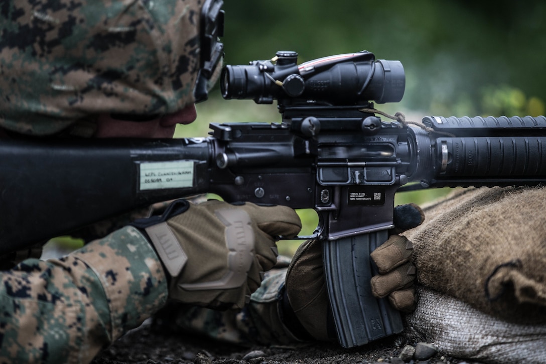 Lance Cpl. Cole Cunningham, a mortar man with Kilo Company, 3rd Battalion, 23rd Marine Regiment, competitor in the 4th Marine Division Annual Rifle Squad Competition, conducts an Unknown Distance course of fire at Joint Base Elmendorf-Richardson, Anchorage, Alaska, August 2, 2018. Super Squad Competitions were designed to evaluate a 14-man infantry squad throughout an extensive field and live-fire evolution. (U.S. Marine Corps photo by Lance Cpl. Samantha Schwoch/released)