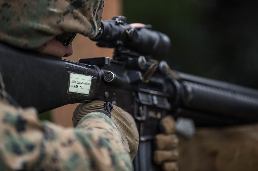Lance Cpl. Cole Cunningham, a mortar man with Kilo Company, 3rd Battalion, 23rd Marine Regiment, competitor in the 4th Marine Division Annual Rifle Squad Competition, conducts an Unknown Distance course of fire at Joint Base Elmendorf-Richardson, Anchorage, Alaska, August 2, 2018. Super Squad Competitions were designed to evaluate a 14-man infantry squad throughout an extensive field and live-fire evolution. (U.S. Marine Corps photo by Lance Cpl. Samantha Schwoch/released)