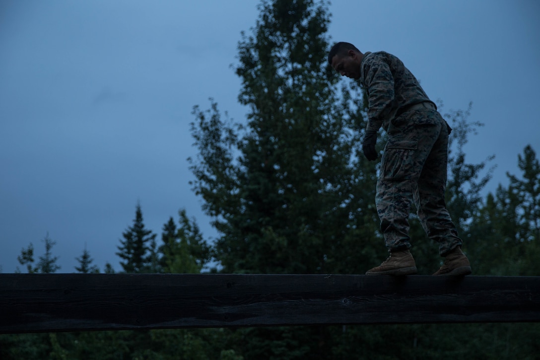 Marines with Charlie Company, 1st Battalion, 23rd Marine Regiment, competing in the 4th Marine Division Annual Rifle Squad Competition, tackle a two-hour timed obstacle course at Joint Base Elmendorf-Richardson, Anchorage, Alaska, August 3, 2018. Super Squad Competitions were designed to evaluate a 14-man infantry squad throughout an extensive field and live-fire evolution. (U.S. Marine Corps photo by Lance Cpl. Samantha Schwoch/released)