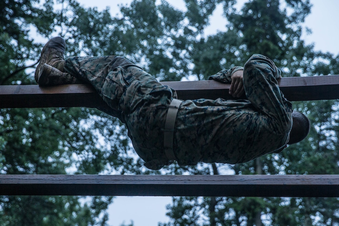 Marines with Charlie Company, 1st Battalion, 23rd Marine Regiment, competing in the 4th Marine Division Annual Rifle Squad Competition, tackle a two-hour timed obstacle course at Joint Base Elmendorf-Richardson, Anchorage, Alaska, August 3, 2018. Super Squad Competitions were designed to evaluate a 14-man infantry squad throughout an extensive field and live-fire evolution. (U.S. Marine Corps photo by Lance Cpl. Samantha Schwoch/released)