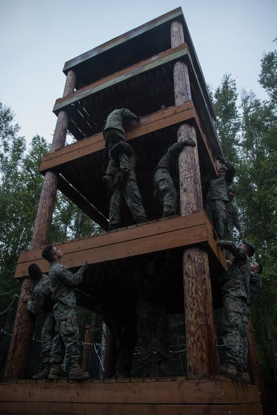 Marines with Charlie Company, 1st Battalion, 23rd Marine Regiment, competing in the 4th Marine Division Annual Rifle Squad Competition, tackle a two-hour timed obstacle course at Joint Base Elmendorf-Richardson, Anchorage, Alaska, August 3, 2018. Super Squad Competitions were designed to evaluate a 14-man infantry squad throughout an extensive field and live-fire evolution. (U.S. Marine Corps photo by Lance Cpl. Samantha Schwoch/released)