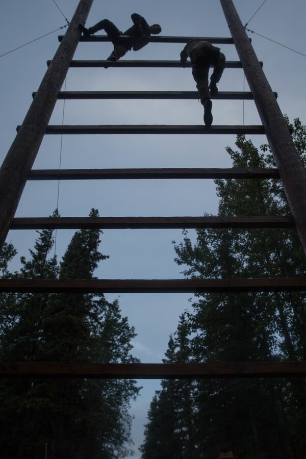 U.S. Marines with Charlie Company, 1st Battalion, 23rd Marine Regiment, competing in the 4th Marine Division Annual Rifle Squad Competition, tackle a two-hour timed obstacle course at Joint Base Elmendorf-Richardson, Anchorage, Alaska, August 3, 2018. Super Squad Competitions were designed to evaluate a 14-man infantry squad throughout an extensive field and live-fire evolution. (U.S. Marine Corps photo by Lance Cpl. Samantha Schwoch)