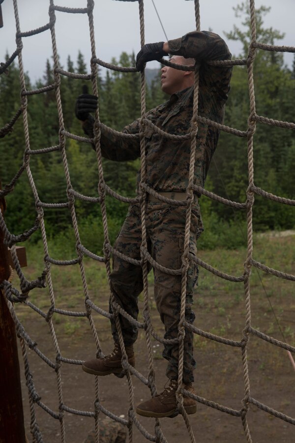 Marine with Charlie Company, 1st Battalion, 23rd Marine Regiment, competing in the 4th Marine Division Annual Rifle Squad Competition, tackle a two-hour timed obstacle course at Joint Base Elmendorf-Richardson, Anchorage, Alaska, August 3, 2018. Super Squad Competitions were designed to evaluate a 14-man infantry squad throughout an extensive field and live-fire evolution. (U.S. Marine Corps photo by Lance Cpl. Samantha Schwoch/released)