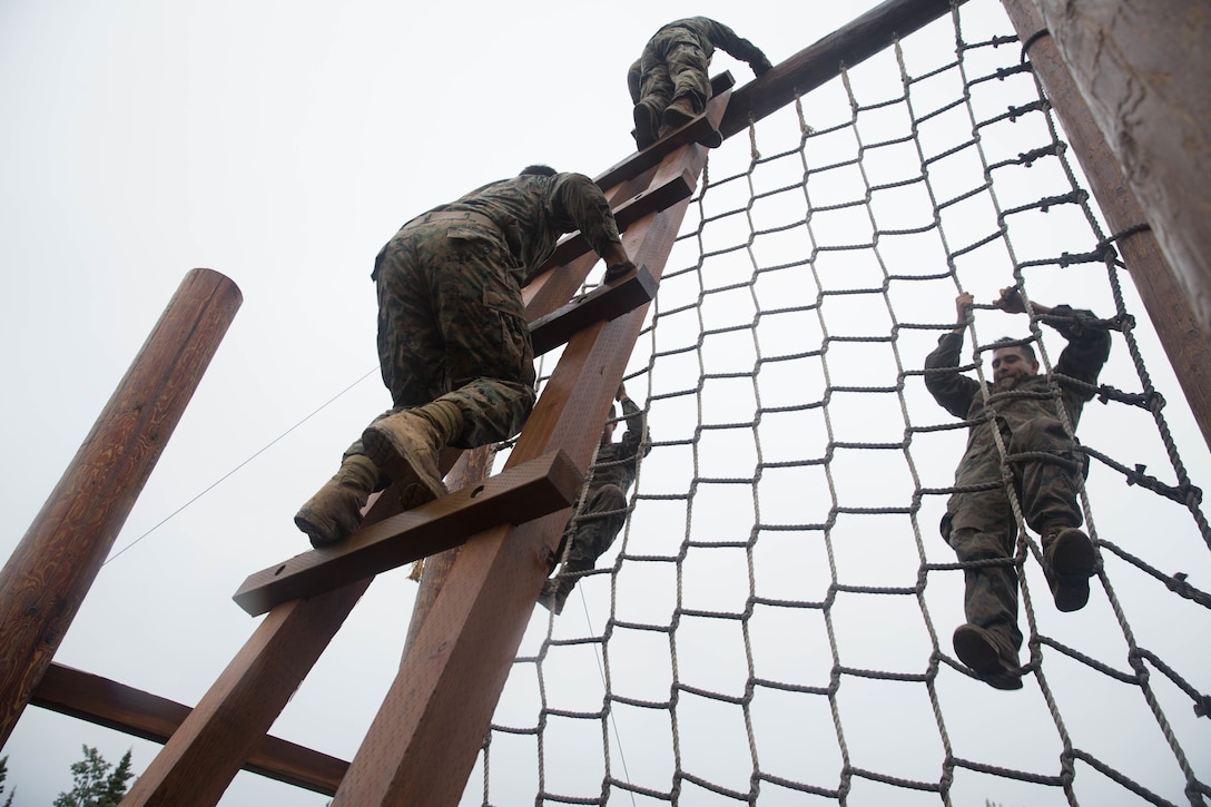 Marines with Charlie Company, 1st Battalion, 23rd Marine Regiment, competing in the 4th Marine Division Annual Rifle Squad Competition, tackle a two-hour timed obstacle course at Joint Base Elmendorf-Richardson, Anchorage, Alaska, August 3, 2018. Super Squad Competitions were designed to evaluate a 14-man infantry squad throughout an extensive field and live-fire evolution. (U.S. Marine Corps photo by Lance Cpl. Samantha Schwoch/released)
