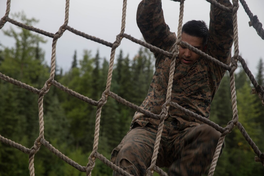 Marines with Charlie Company, 1st Battalion, 23rd Marine Regiment, competing in the 4th Marine Division Annual Rifle Squad Competition, tackle a two-hour timed obstacle course at Joint Base Elmendorf-Richardson, Anchorage, Alaska, August 3, 2018. Super Squad Competitions were designed to evaluate a 14-man infantry squad throughout an extensive field and live-fire evolution. (U.S. Marine Corps photo by Lance Cpl. Samantha Schwoch/released)