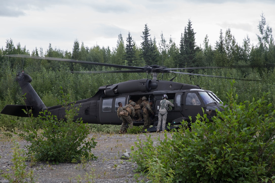 Marines with Charlie Company, 1st Battalion, 23rd Marine Regiment, competing in the 4th Marine Division Annual Rifle Squad Competition, board a U.S. Army Sikorsky UH-60 Black Hawk at Joint Base Elmendorf-Richardson, Anchorage, Alaska, Aug. 3, 2018. Super Squad Competitions were designed to evaluate a 14-man infantry squad throughout an extensive field and live-fire evolution. (U.S. Marine Corps photo by Lance Cpl. Samantha Schwoch/released)