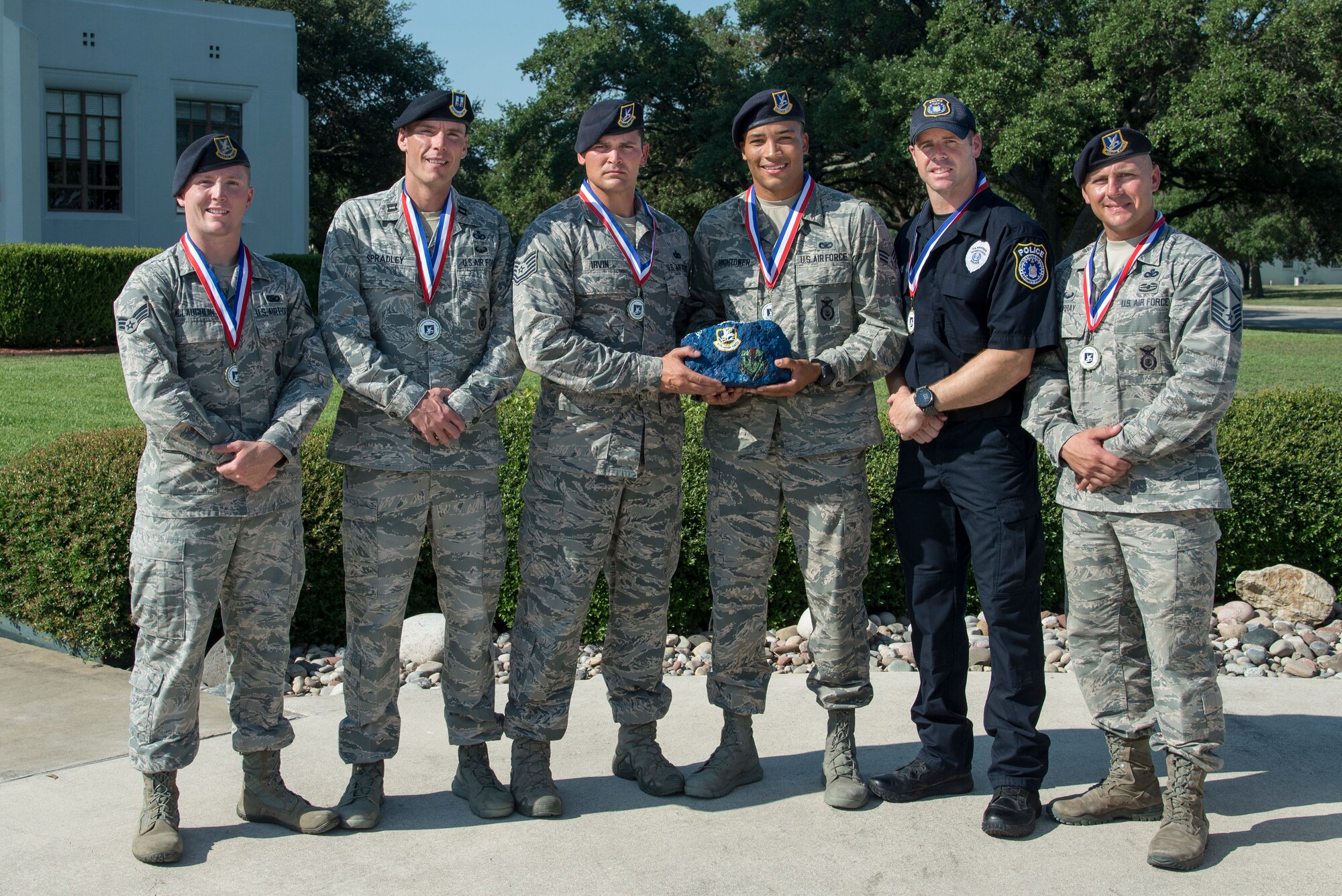 (left to right) Senior Airman William McLaughlin, 502nd Security Forces Squadron, Capt. Nathan Spradley, 902nd SFS, Technical Sgt. Cory Irvin, 37th Training Support Squadron, Senior Airman David Hightower, 56th SFS, Officer Jonathan Vance and Master Sgt. James Murray of the 802nd SFS, pose for a photo after being chosen as the representatives of Air Education and Training Command’s Defender Challenge team July 27, 2018, at Joint Base San Antonio-Randolph, Texas. Defender Challenge is a Security Forces competition that pits teams against each other in realistic weapons, dismounted operations and relay challenge events.