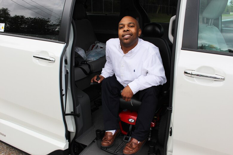 Barry Goode, a PALACE ACQUIRE intern with the Air Force Life Cycle Management Center's Business and Enterprise Systems Directorate, poses with the van he received with assistance from co-workers.