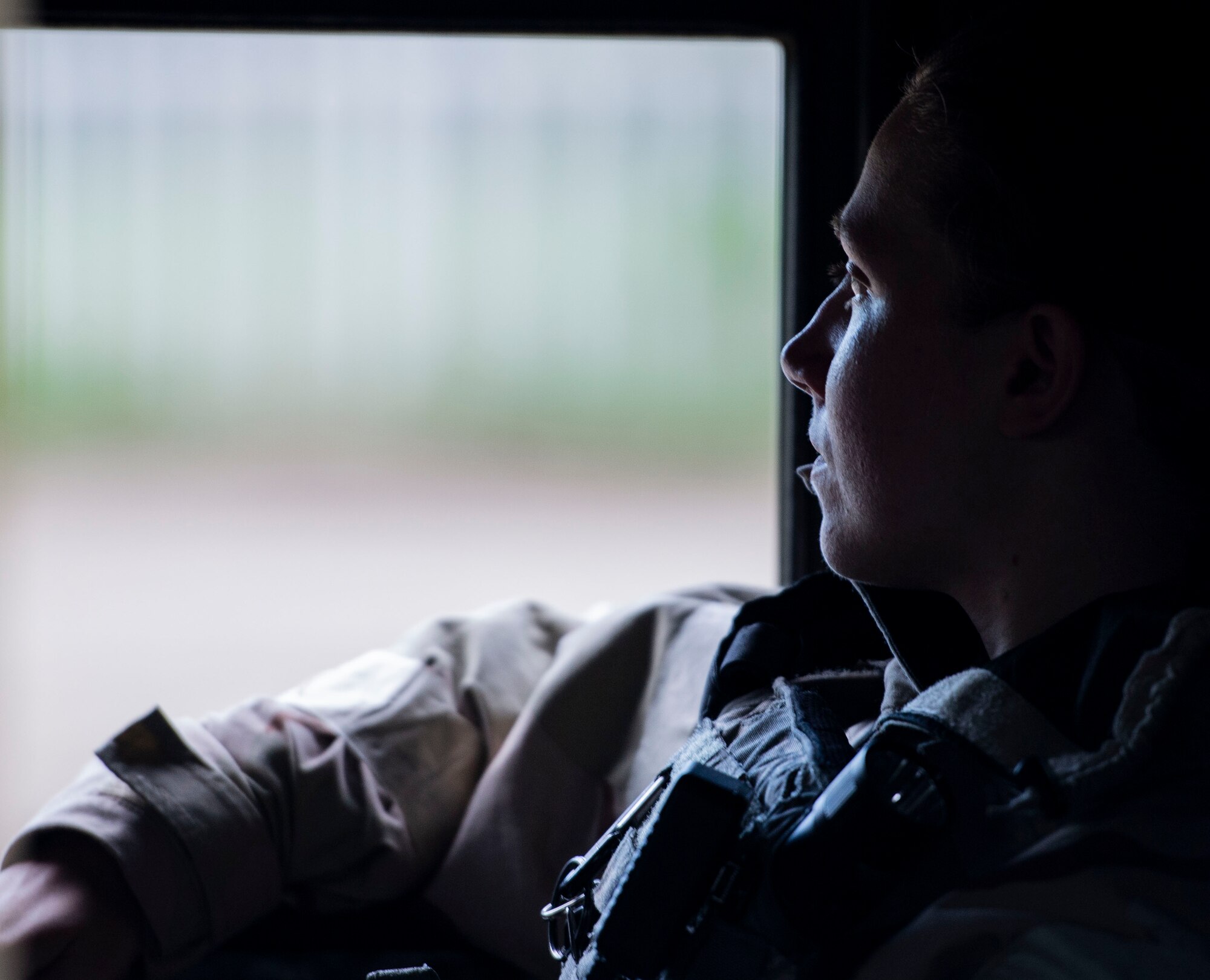 Senior Airman Taylor Pitts, 375th Security Forces Squadron patrolman, looks out the window of a Security Forces Humvee before patrolling the exercise zone during a base exercise, Aug. 2, 2018, at Scott Air Force Base, Illinois. Pitts was one of four 375th SFS Airmen tasked with patrolling the perimeter of the training area. (U.S. Air Force photo by Airman 1st Class Tara Stetler)