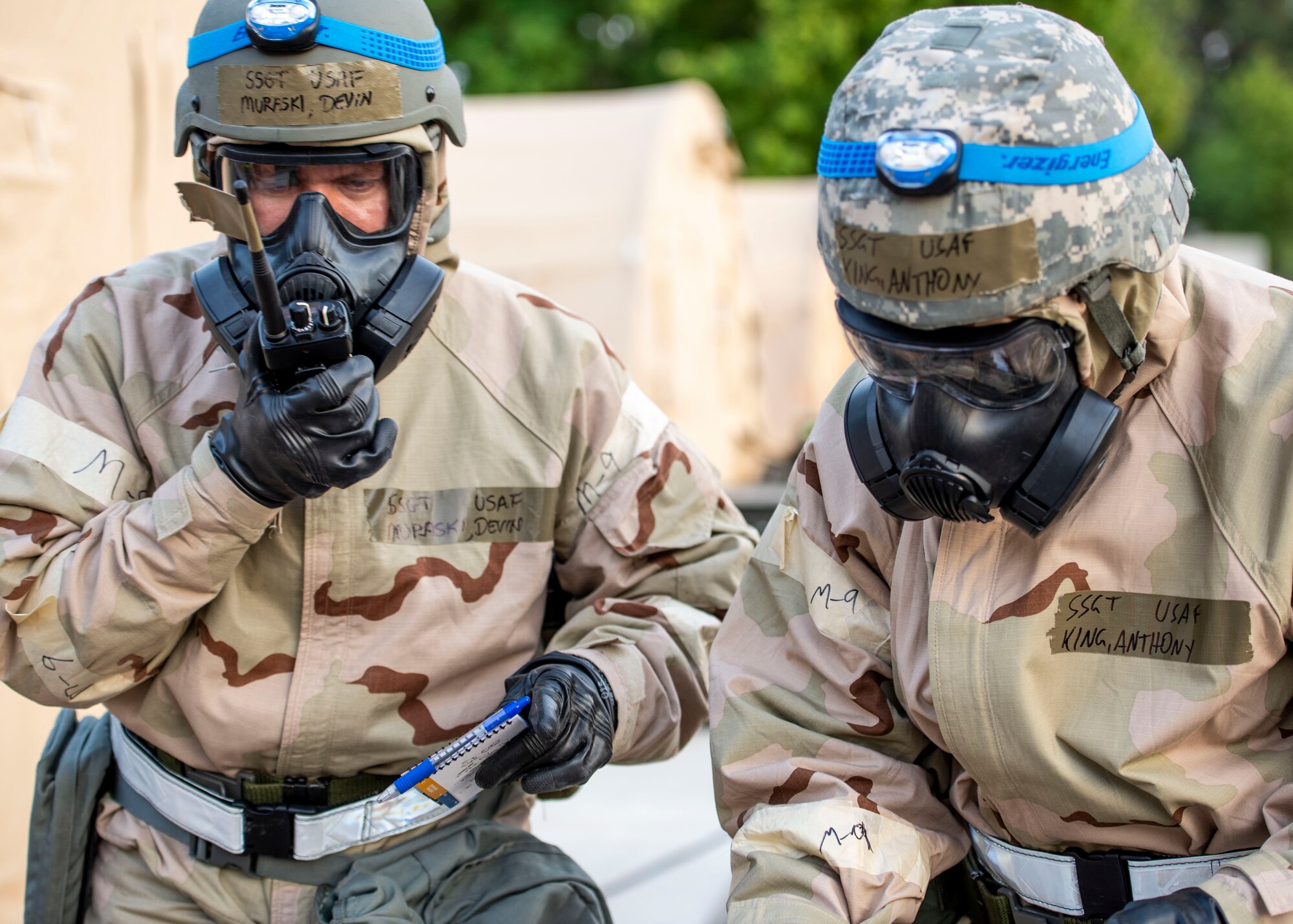 Staff Sgt. Devin Muraski, 932nd Operations Support Flight aircrew flight equipment craftsman, and Staff Sgt. Anthony King, 73rd Airlift Squadron aviation resource management craftsman, perform a Post Attack Reconnaissance sweep during a base exercise, Aug. 2, 2018, at Scott Air Force Base, Illinois. PAR sweeps are the first step of recovery after an attack, and they ensure the area is clear of unexploded ordinance devices and chemical agents. (U.S. Air Force photo by Airman 1st Class Tara Stetler)