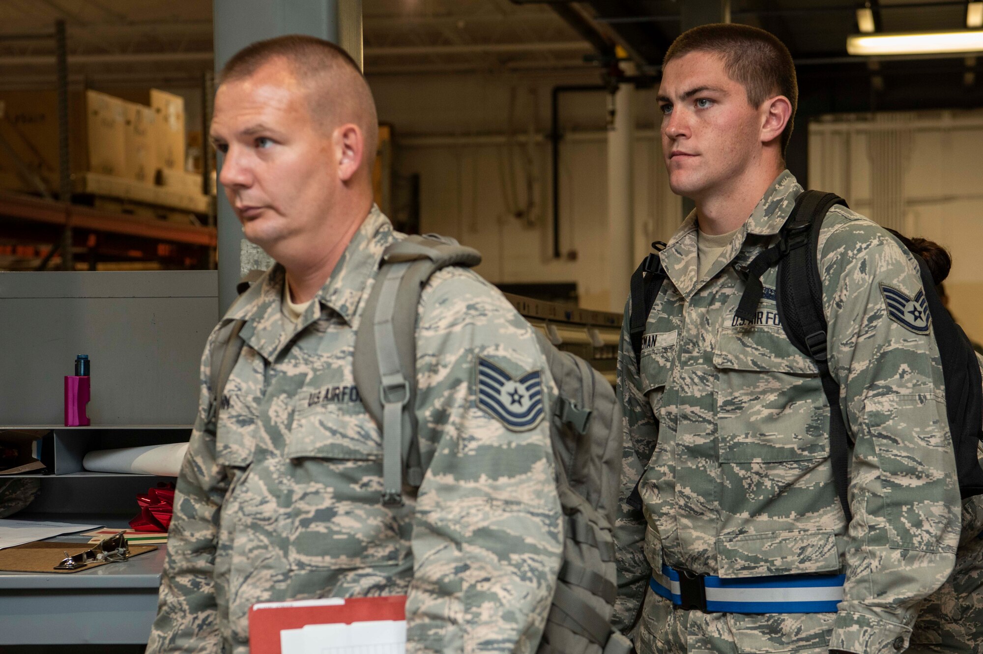 Airmen participating in a base exercise go through a simulated pre-deployment line, July 30, 2018, at Scott Air Force Base, Illinois. Throughout the exercise, blue belts indicated that Airmen were players, while yellow belts indicated they were observers. (U.S. Air Force photo by Senior Airman Melissa Estevez)