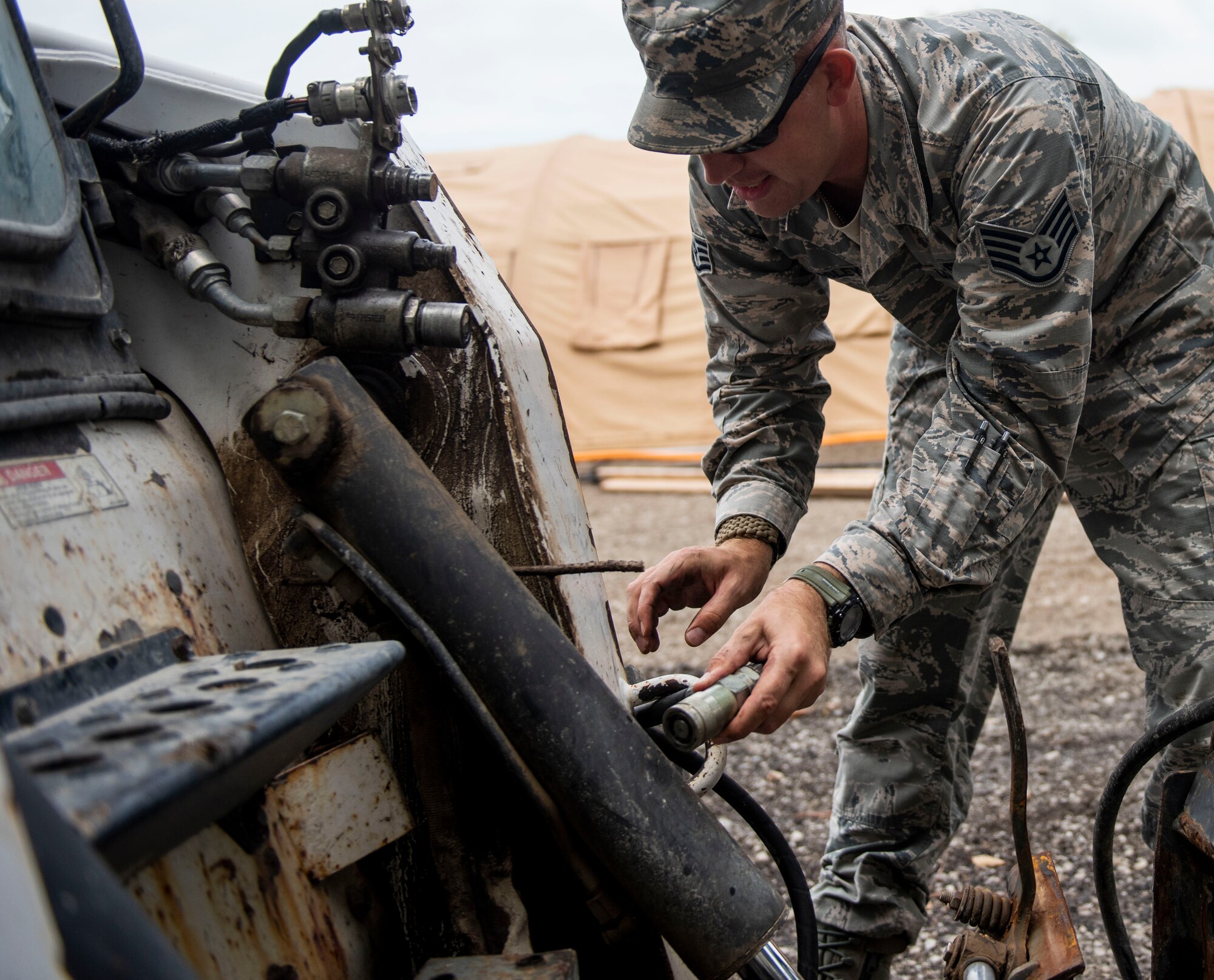 Staff Sgt. Chad Beasley, 375th Civil Engineer Squadron pavements and equipment craftsman, hooks-up a forklift during a base exercise, July 31, 2018, at Scott Air Force Base, Illinois. The exercise required coordination between active duty and reserve units on base, such as the 375th Air Mobility Wing and the 932 Airlift Wing. (U.S. Air Force photo by Airman 1st Class Tara Stetler)