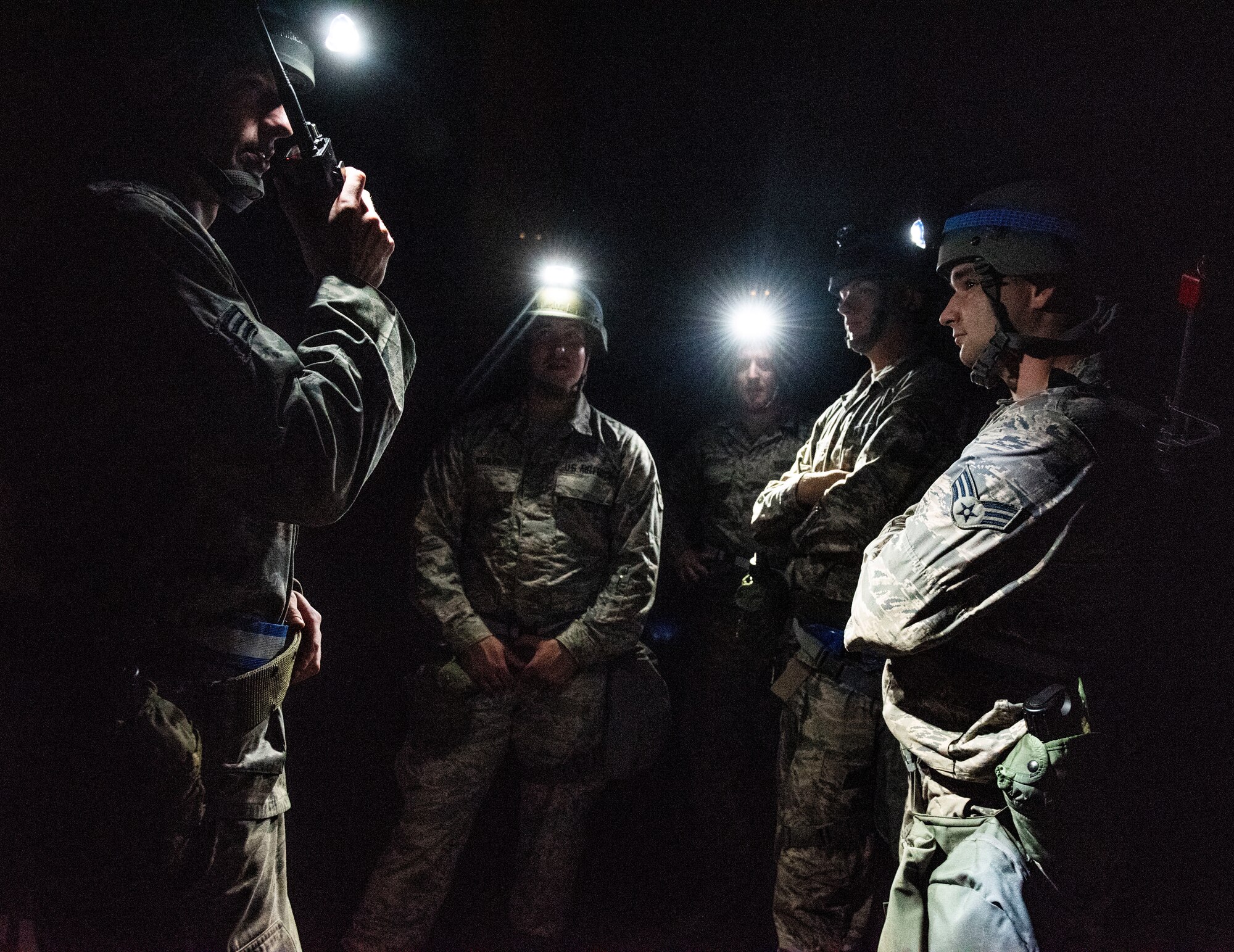 Senior Airman Max Shumate, 375th Civil Engineer Squadron structural journeyman, uses a hand-held radio to get direction from his leadership during a base exercise, Aug. 1, 2018, at Scott Air Force Base, Illinois. Shumate was part of a group of 375th CES Airmen responsible for responding to several simulated explosions near the training area. (U.S. Air Force photo by Airman 1st Class Tara Stetler)