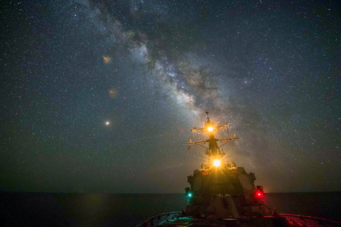 The guided-missile destroyer USS Jason Dunham transits the Red Sea at night.