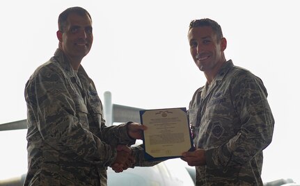 Lt. Col. David Morales, 437th Operations Support Squadron outgoing commander, is awarded the Meritorious Service Medal by Col. Daniel Dobbels, 437th Operations Group commander, during a change of command ceremony, Aug. 3, 2018 at Joint Base Charleston. The 437th OSS is responsible for airfield management, life support services, flight records management, weather and intelligence support, airlift scheduling, tactical employment and aircrew training for approximately 1,400 active and reserve service members.