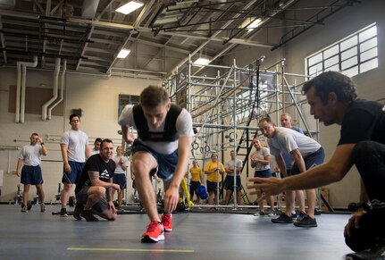 Airmen and Sailors cheer on a classmate during the Alpha Warrior Air Force Fitness Tour Level 1 Battle Rig Instructor Course Aug. 1, 2018, at the Fitness Center at Joint Base Charleston, S.C.