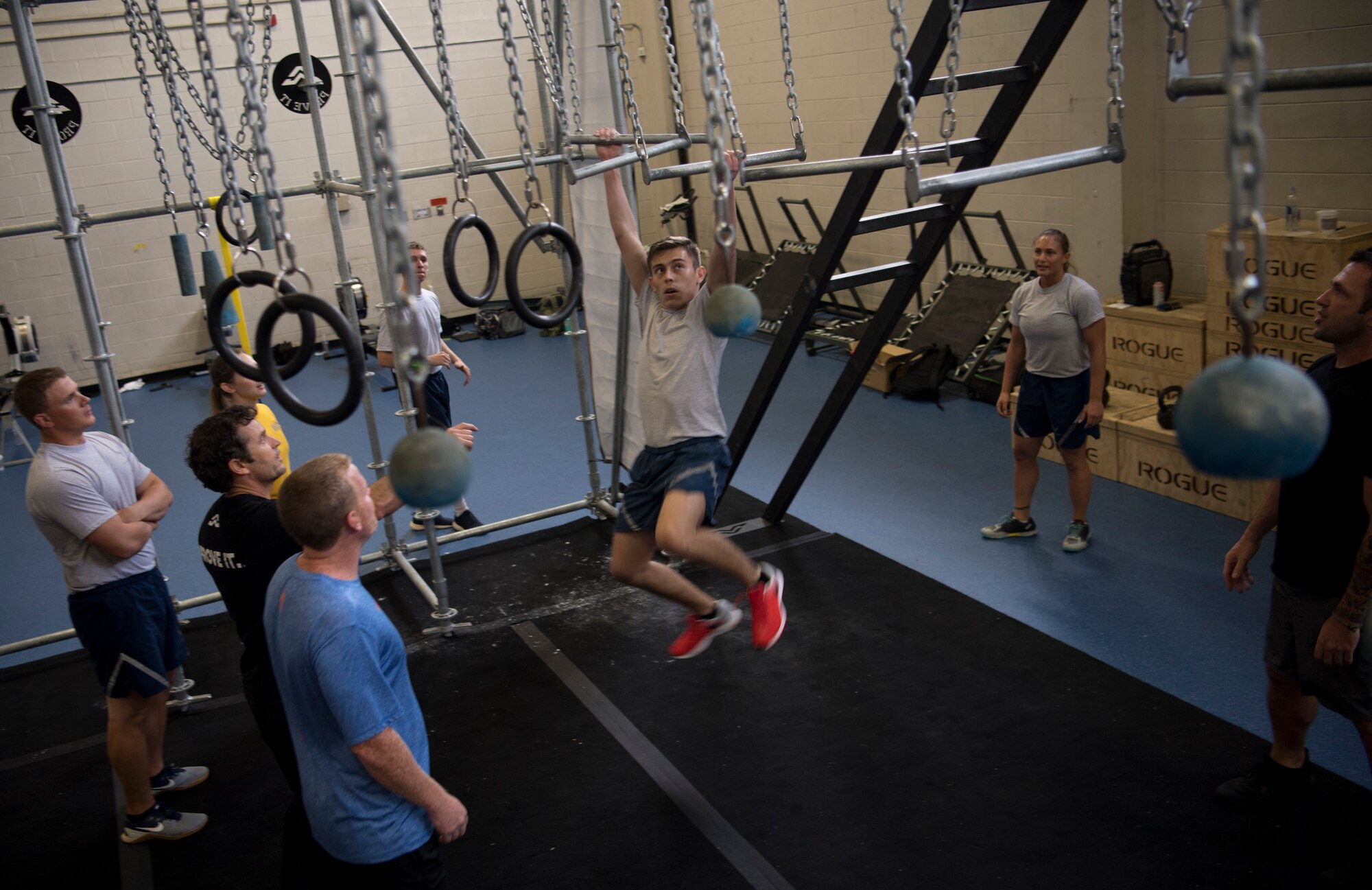 Airmen and Sailors cheer on a classmate during the Alpha Warrior Air Force Fitness Tour Level 1 Battle Rig Instructor Course Aug. 1, 2018, at the Fitness Center at Joint Base Charleston, S.C