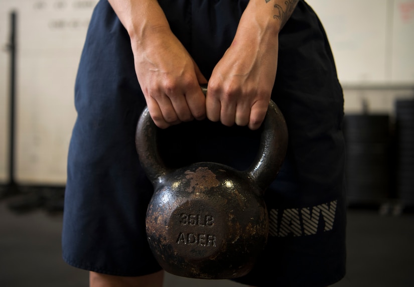 A Sailor holds a kettlebell during the Alpha Warrior Air Force Fitness Tour Level 1 Battle Rig Instructor Course Aug. 1, 2018, at the Fitness Center at Joint Base Charleston, S.C.