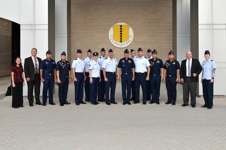 Royal Thai air force leadership pose for a photo with Pacific Air Forces, 17th Training Wing and Air Force Security Assistance Training Squadron leadership outside the Norma Brown building during a tour on Goodfellow Air Force Base, Texas, Aug. 2, 2018. The overall intent for the visit was to share with RTAF partners how the U.S. Air Force organizes, trains and equips its intelligence professionals to achieve mission success. (U.S. Air Force photo by Senior Airman Randall Moose/Released)