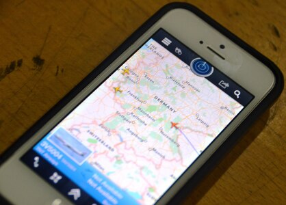 E-3A Component personnel use an iPhone application to track the arrival of a TNT aircraft Nov. 18, 2014, at NATO Air Base Geilenkirchen, Germany. Under a new DoD directive, devices with geolocation capabilities won't be allowed in deployment situations.