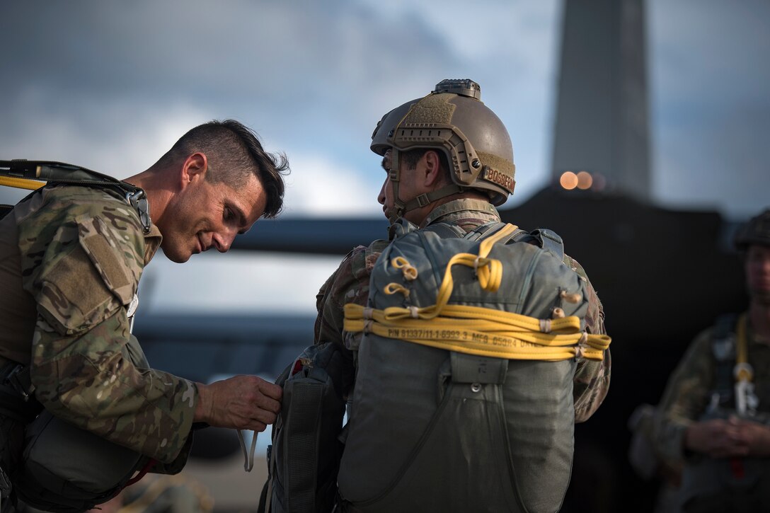 Master Sgt. Craig Stott, left, 824th Base Defense Squadron squad leader, and Staff Sgt. Rodney Bosserman, 824th BDS fireteam leader, prepare for a static-line jump, July 31, 2018, at Moody Air Force Base, Ga. The 820th Base Defense Group includes airborne-qualified Airmen to bolster its worldwide-deployable force-protection capability and requires them to jump periodically to maintain their qualification. (U.S. Air Force photo by Staff Sgt. Ryan Callaghan)