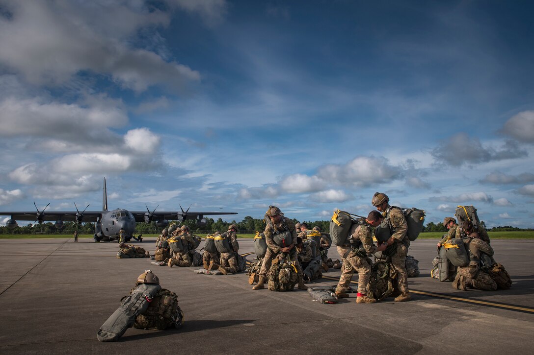 Airmen from the 820th Base Defense Group prepare for static-line jumps, July 31, 2018, at Moody Air Force Base, Ga. The 820th BDG includes airborne-qualified Airmen to bolster its worldwide-deployable force-protection capability and requires them to jump periodically to maintain their qualification. (U.S. Air Force photo by Staff Sgt. Ryan Callaghan)