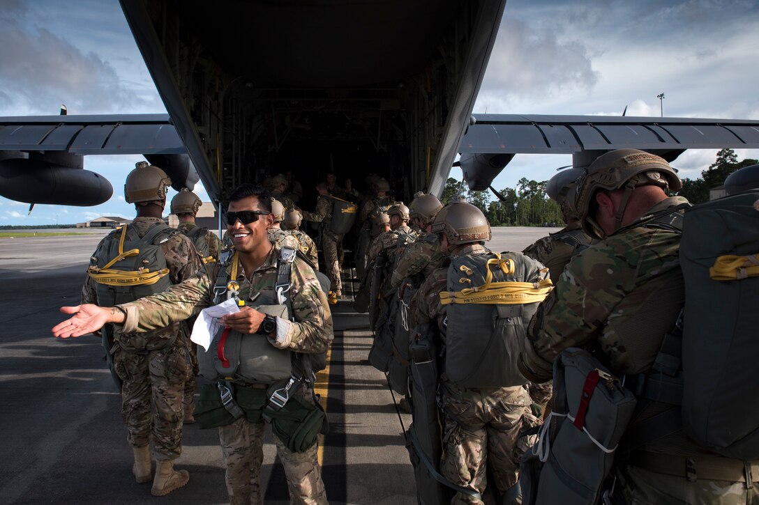 Tech. Sgt. Christopher Zavala, 822nd Base Defense Squadron jumpmaster, counts jumpers as they board an HC-130J Combat King II, July 31, 2018, at Moody Air Force Base, Ga. The 820th Base Defense Group includes airborne-qualified Airmen to bolster its worldwide-deployable force-protection capability and requires them to jump periodically to maintain their qualification. (U.S. Air Force photo by Staff Sgt. Ryan Callaghan)