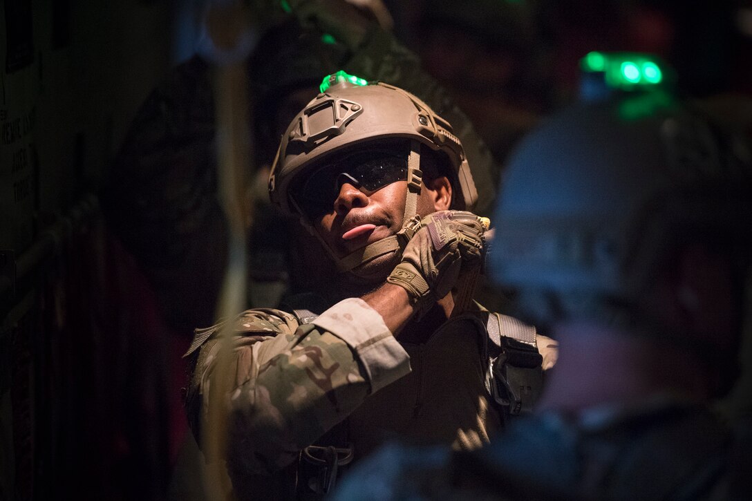 An Airman from the 820th Base Defense Group prepares for a static-line jump in the rear of an HC-130J Combat King II, July 31, 2018, in the skies over South Georgia. The 820th BDG includes airborne-qualified Airmen to bolster its worldwide-deployable force-protection capability and requires them to jump periodically to maintain their qualification. (U.S. Air Force photo by Staff Sgt. Ryan Callaghan)