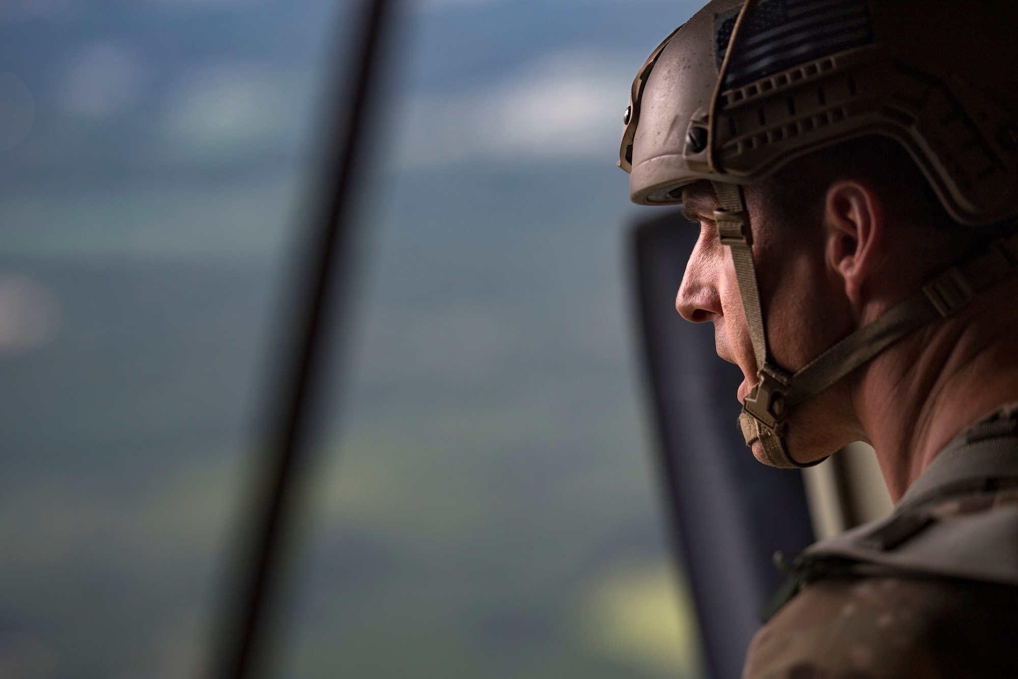 Master Sgt. Craig Stott, 824th Base Defense Squadron jumpmaster, scans the drop zone below prior to a static-line jump from an HC-130J Combat King II, July 31, 2018, in the skies over South Georgia. The 820th Base Defense Group includes airborne-qualified Airmen to bolster its worldwide-deployable force-protection capability and requires them to jump periodically to maintain their qualification. (U.S. Air Force photo by Staff Sgt. Ryan Callaghan)