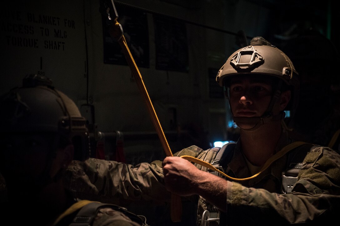 An Airman from the 820th Base Defense Group prepares for a static-line jump in the rear of an HC-130J Combat King II, July 31, 2018, in the skies over South Georgia. The 820th BDG includes airborne-qualified Airmen to bolster its worldwide-deployable force-protection capability and requires them to jump periodically to maintain their qualification. (U.S. Air Force photo by Staff Sgt. Ryan Callaghan)