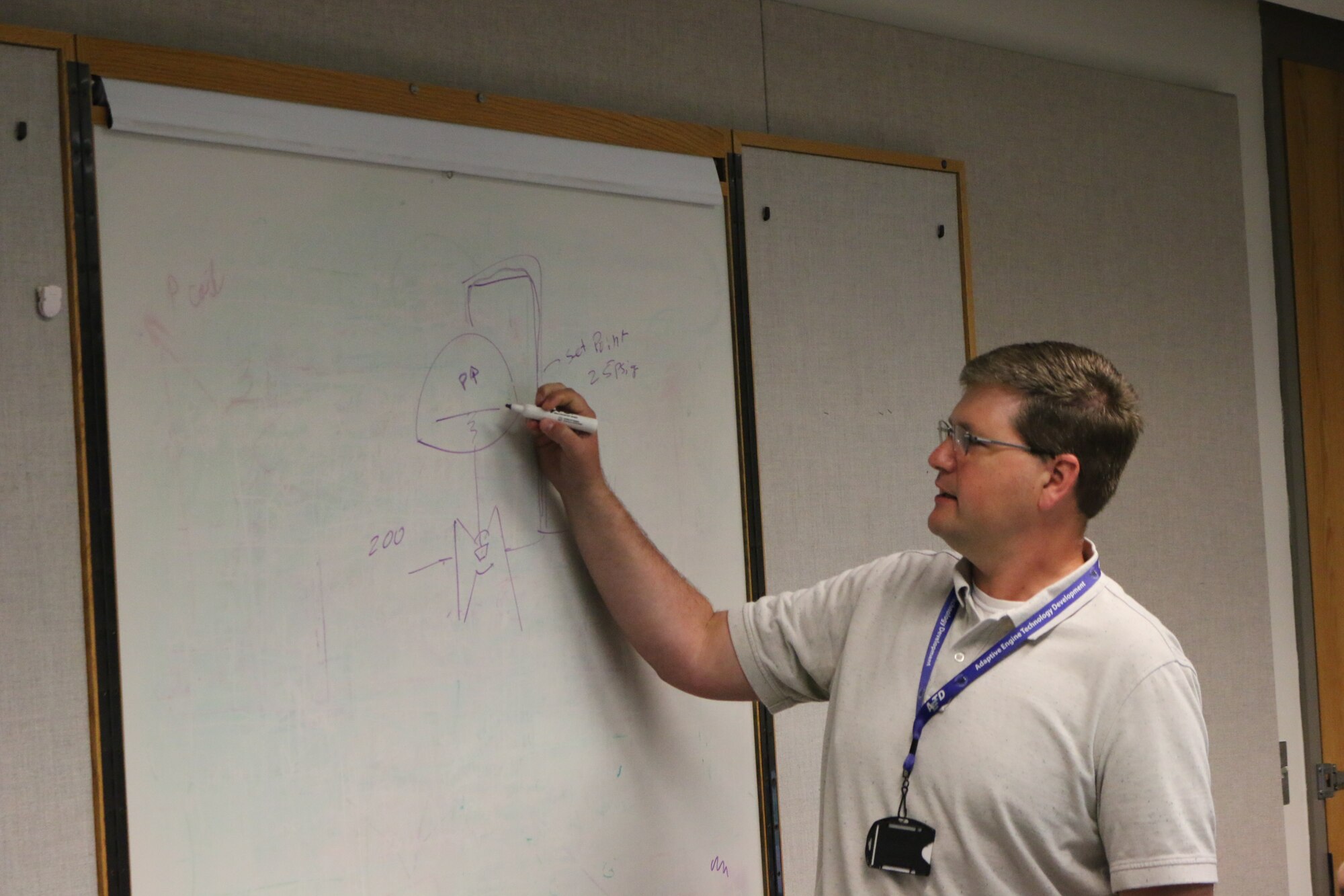 Austin Voorhes, a senior mechanical design engineer at Arnold Air Force Base, discusses steam regulators during a lunch and learn session in the Carroll Building on July 25. Voorhes was recently recognized for establishing the lunch and learns at Arnold. More than 100 lunch and learns have been held since Voorhes began the effort a little more than three years ago. (U.S. Air Force photo by Bradley Hicks)