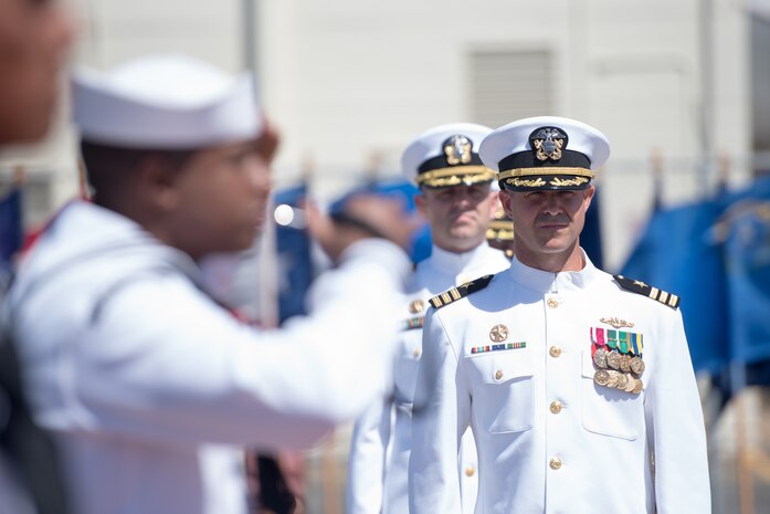 PEARL HARBOR (August 3, 2018) - Cmdr. Tyler Forrest walks through the side boys during the change of command ceremony for Los Angles-class fast-attack submarine USS Columbia (SSN 771) on the historic submarine piers at Joint Base Pearl Harbor-Hickam, August 3. Cmdr. Tyler Forrest relieved Cmdr. Dave Edgerton as Columbia’s commanding officer. (U.S. Navy photo by Mass Communication Specialist 1st Class Daniel Hinton)