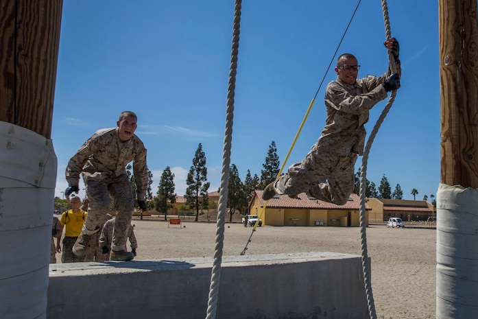 Recruits with Hotel Company, 2nd Recruit Training Battalion, swing across an obstacle during Confidence Course I at Marine Corps Recruit Depot San Diego, July 30.