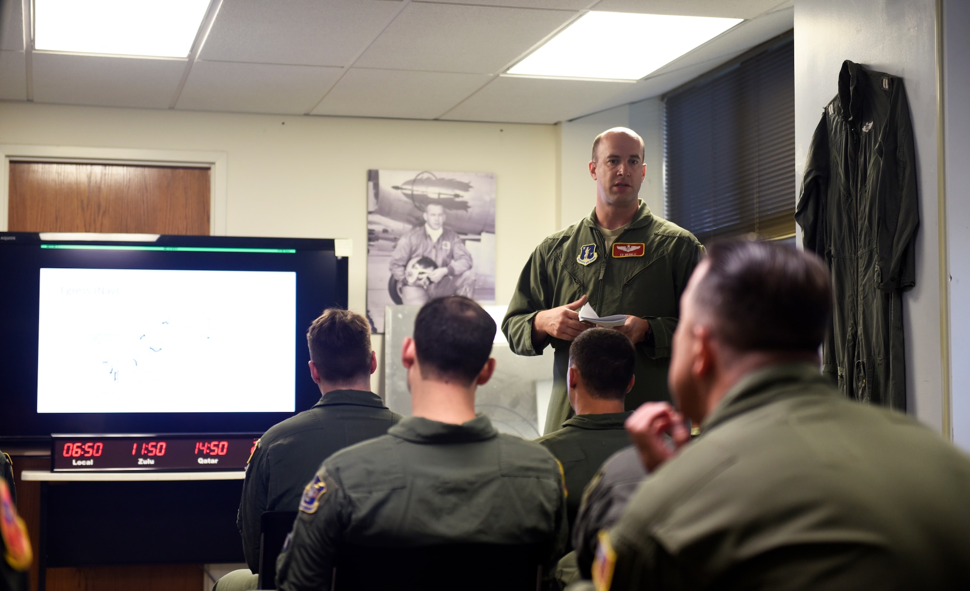 Nebraska National Guard Maj. Ed Merkle, 238th Combat Training Squadron navigator, briefs emergency egress procedures during a preflight briefing before departing for a weekend training sortie at Offutt Air Force Base, Nebraska Aug. 5, 2018. The objective of the briefing is to communicate a common operating picture of meteorological and aeronautical information to the entire crew necessary for the conduct of a safe and efficient flight. (U.S. Air Force photo by 2nd Lt. Drew Nystrom)