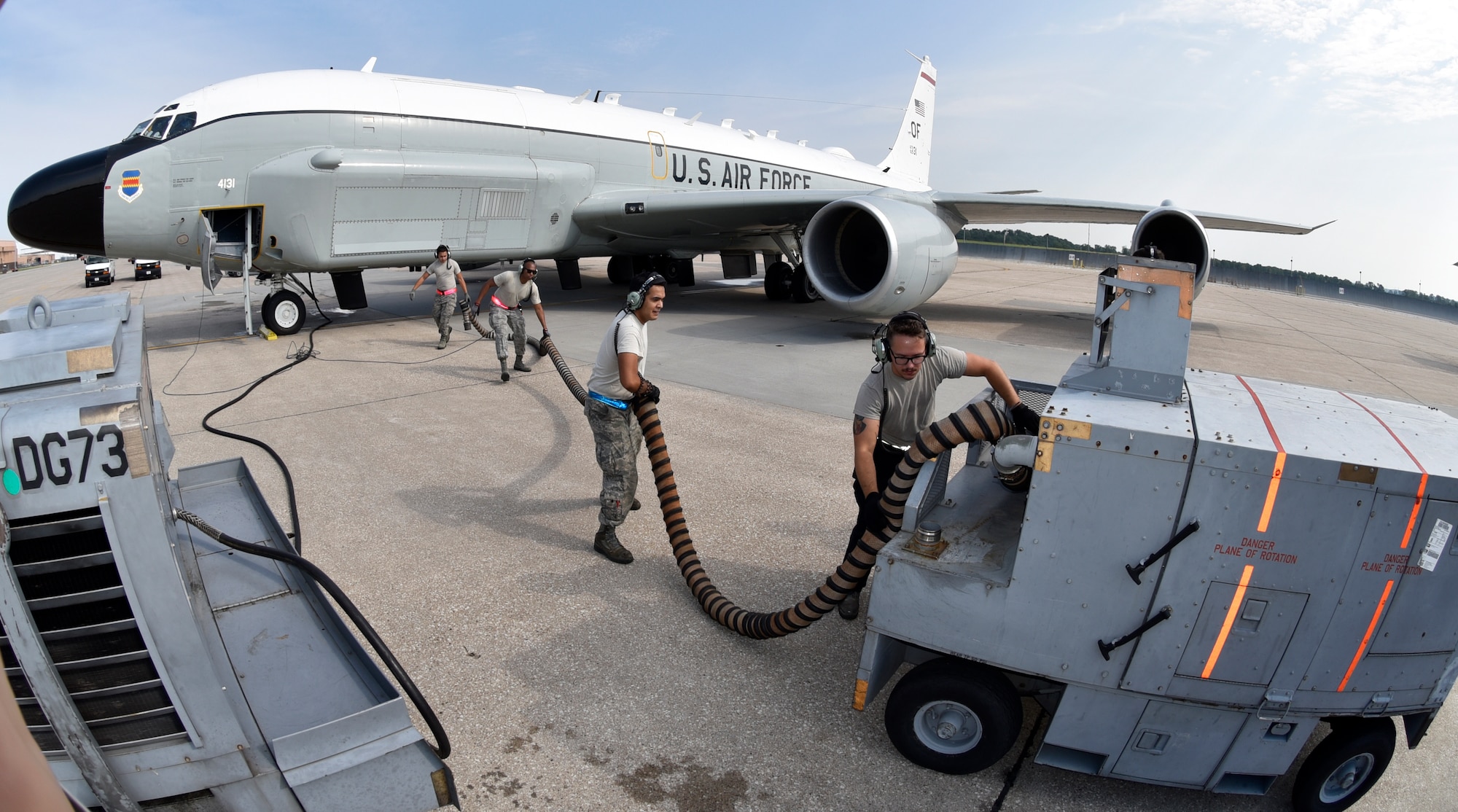 55th Aircraft Maintenance Squadron Airmen (from right to left) Senior Airman Nick Brown, Senior Airman Angel Marroquin, Senior Airman Eric Kline and Airman First Class Kawika Toledano, stow an air hose from an air cart after starting a RC-135V/W Rivet Joint's four CFM International F108-CF-201 high-bypass turbofan engines Aug. 5, 2018 at Offutt Air Force Base, Nebraska. (U.S. Air Force photo by 2nd Lt. Drew Nystrom)