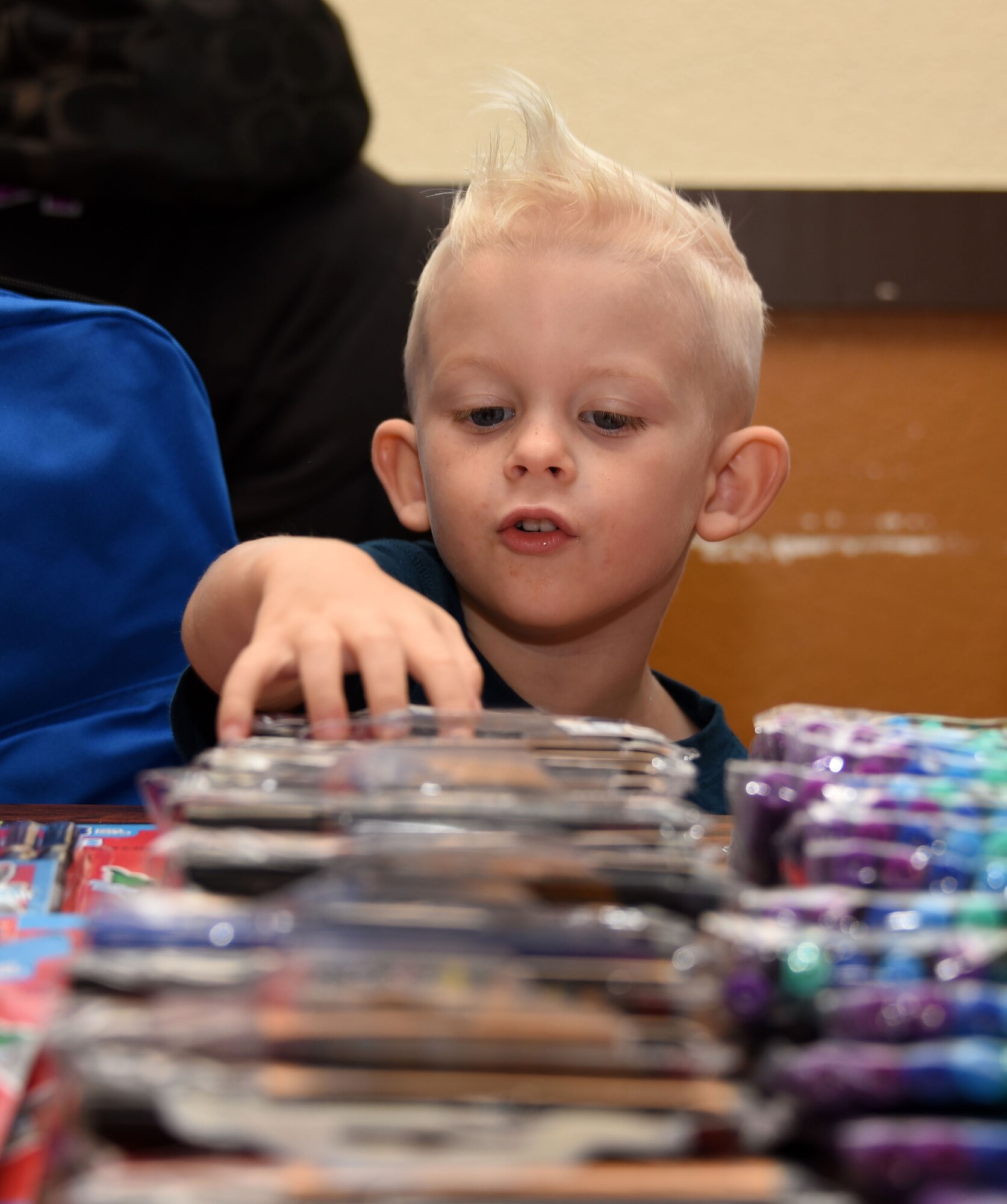 A child browses art supplies during Operation Homefront’s “Back to School Brigade” Aug. 2 at the base’s First Street Chapel. The event helped to provide children of E-1 to E-6 Airmen with free school supplies for the upcoming academic year. (U.S. Air Force photo by Airman 1st Class Christian Conrad)