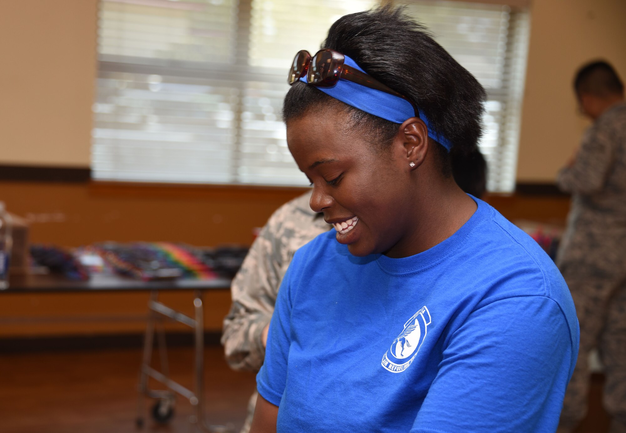 A volunteer from Travis Air Force Base, Calif., helps in directing Travis children through a catalog of school supplies as part of Operation Homefront’s “Back to School Brigade” Aug. 2 at the base’s First Street Chapel. The event helped to provide children of E-1 to E-6 Airmen with free school supplies for the upcoming academic year. (U.S. Air Force photo by Airman 1st Class Christian Conrad)
