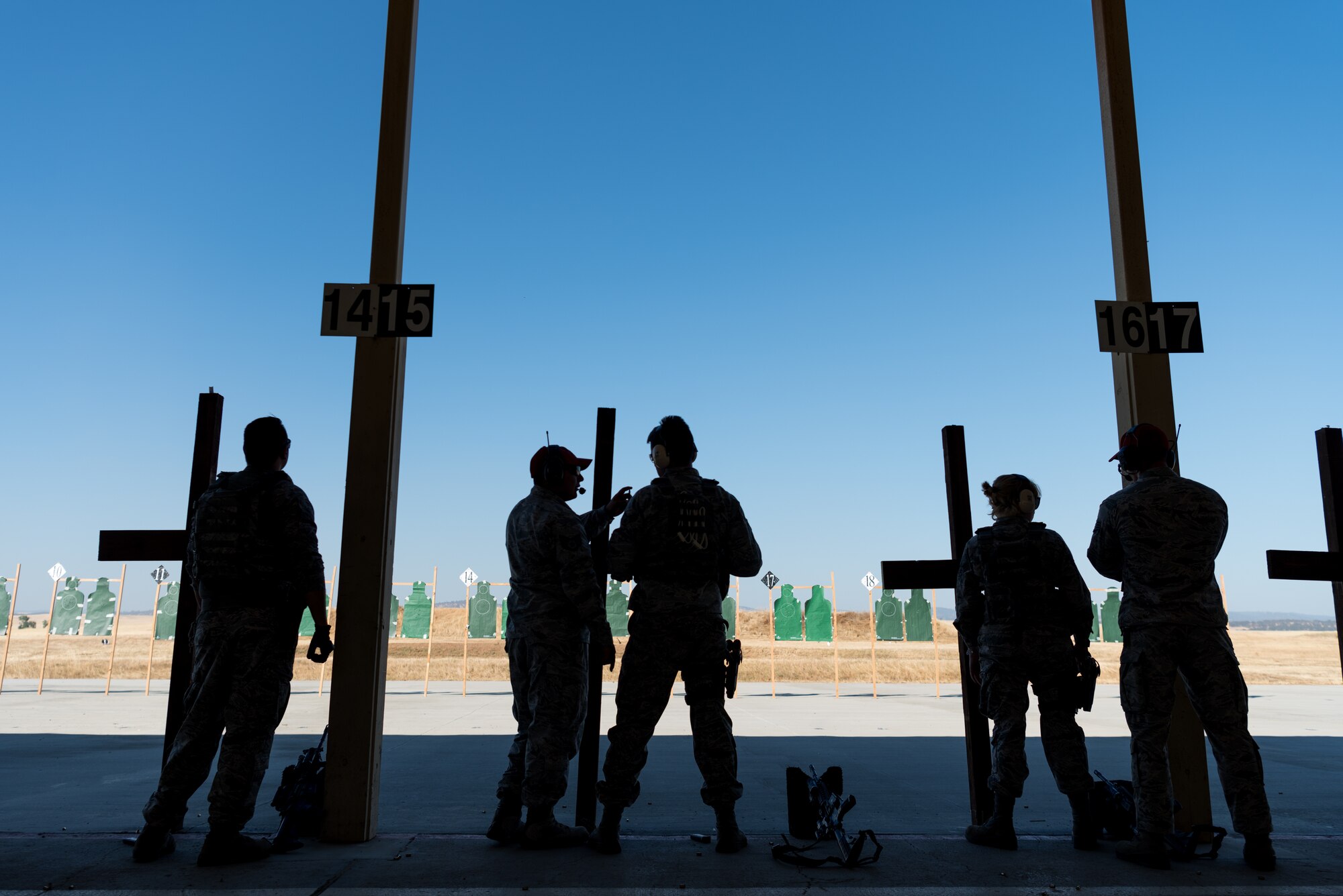 Airmen with the 9th and 940th Security Forces combat arms training and maintenance shop work alongside each other during range instruction at Beale Air Force Base, California, July 7, 2018. Airmen from both the active-duty component and reserves use the same range for qualification. (U.S. Air Force photo by Senior Airman Justin Parsons)