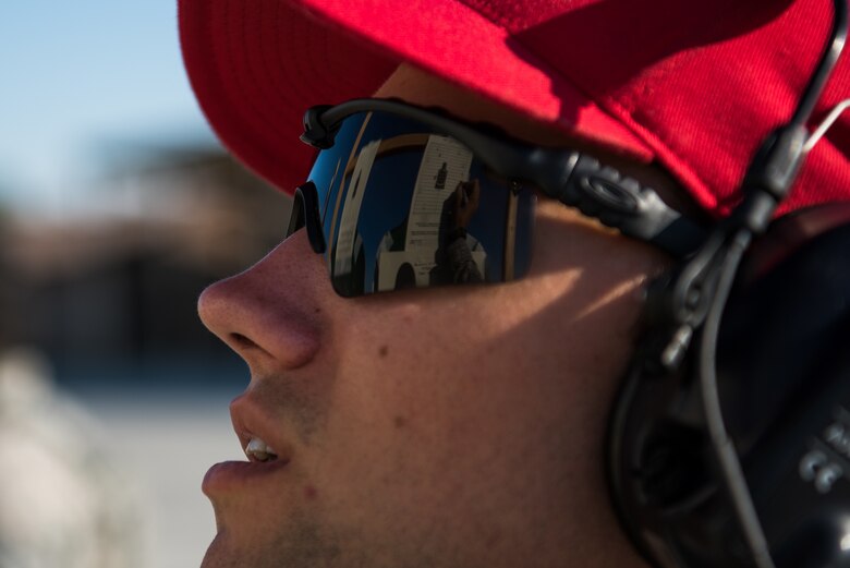 Senior Airman Paul Rathbum, 940th Security Forces combat arms training and maintenance instructor, counts the number of valid strikes on a target silhouette during a qualification course he is instructing at Beale Air Force Base, California July 6, 2018. Airmen instructors with the 940th will work on active orders after initial combat arms training. (U.S. Air Force photo by Senior Airman Justin Parsons)