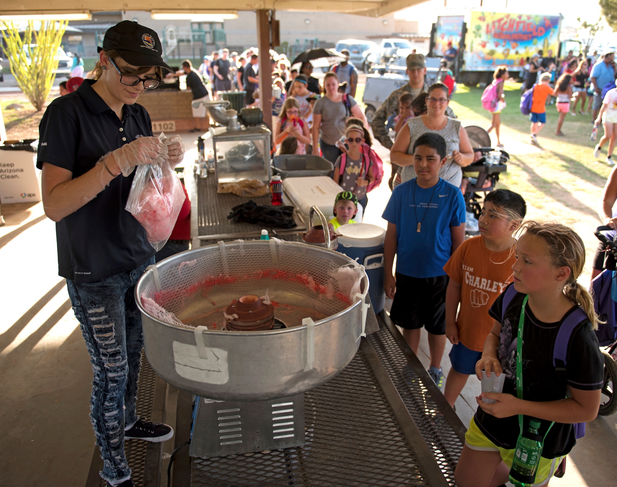 Children and families line up to get free cotton candy during the Back-To-School Bash July 25, 2018, at Luke Air Force Base, Ariz. The Bash included free food and drinks for all attendees. (U.S. Air Force photo by Senior Airman Ridge Shan)