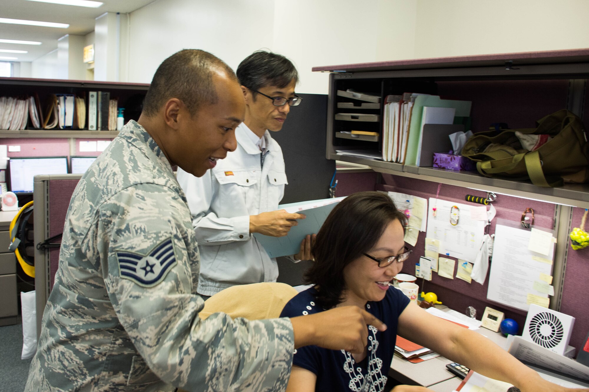 Members from the 374th Contracting Squadron look over a contract to keep U.S. Army base Camp Zama in good repair, Aug 2, 2018, Yokota Air Base, Japan.